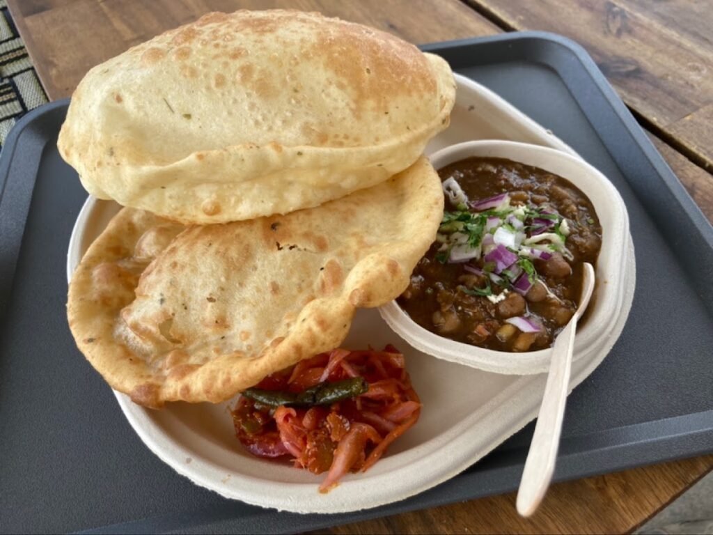 Chole bhature at Flavours On Wheels: two puffed bhature with chana masala, onion and pickle